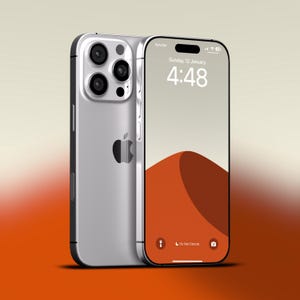 May include: Silver smartphone with a triple-lens camera system and a black Apple logo. The screen displays the date, time, and a desert landscape. The phone has a sleek, modern design with a silver frame and black accents.