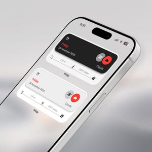 May include: A close-up of a smartphone displaying a weather and activity tracking app. The screen shows the date, time, temperature, and step count. The app interface is clean with a black and white color scheme and red accents. The phone is silver.
