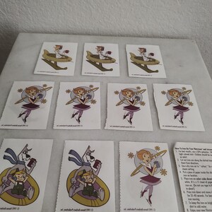 May include: A collection of vintage iron-on transfers featuring cartoon characters. The transfers depict a man in a flying vehicle, a woman in a futuristic outfit, and a cartoon dog with a child. Instructions are included.