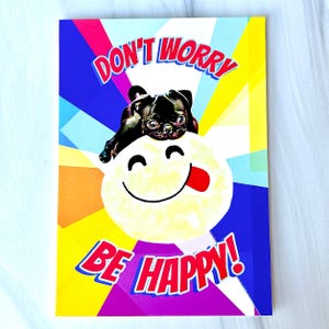 May include: A colorful card with a pug dog and a smiley face. The card says "Don't Worry Be Happy!"