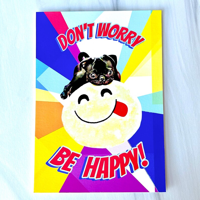 May include: A colorful card with a pug dog and a smiley face. The card says "Don't Worry Be Happy!"