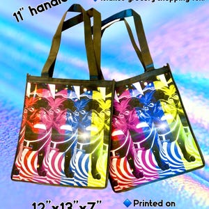 May include: Two reusable shopping bags with 11-inch handles. The bags are made of a lightweight, sturdy, and decomposable material. The bags feature a colorful, psychedelic design with a repeated image of a pug dog. The bags are 12 inches by 13 inches by 7 inches and are printed on both sides. "Makes grocery shopping fun!" is printed on the top of the image.