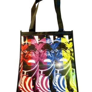 May include: A black tote bag with a colorful pop art design of a pug dog. The dog is depicted in four different colors: red, pink, blue, and yellow. The background is a swirling pattern of black and white stripes.