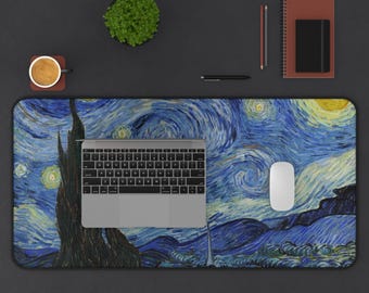 May include: A rectangular desk mat featuring Van Gogh's "Starry Night" painting in blue, yellow, and white. A laptop, mouse, coffee cup, pen, notebook, and small plant are on the mat. The desk mat is a functional and decorative office accessory.