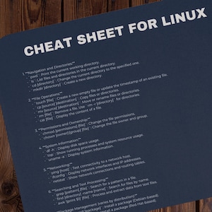 May include: A blue cheat sheet with white text outlining common Linux commands for navigation, file operations, permissions, system information, networking, searching, and text processing.