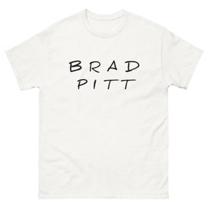 May include: White t-shirt with the text "BRAD PITT" written in black marker.