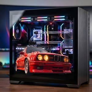 May include: A custom-built computer case with a clear side panel, showcasing internal components and a red model car. The case features colorful LED lighting and water cooling components. The car model is a classic red sports car.