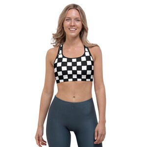 May include: A black and white checkered sports bra with a racerback design.