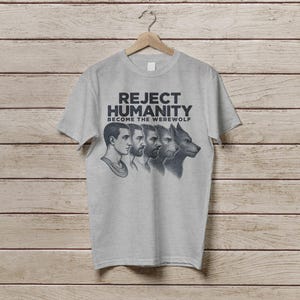 May include: A grey t-shirt with the text "Reject Humanity Become the Werewolf" and a graphic of a man transforming into a werewolf.