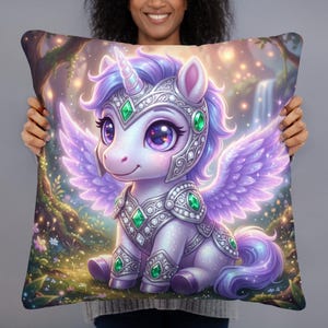 May include: A square throw pillow featuring a digital illustration of a purple unicorn with wings, wearing ornate silver armor adorned with green gemstones. The unicorn is set against a background of a glowing forest with soft lights and a waterfall.