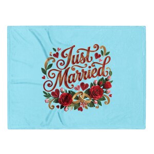 May include: A light blue fleece blanket featuring the text Just Married in a decorative red script font. The design includes two gold wedding rings, vibrant red roses, green leaves, and small red hearts arranged in a circular pattern.