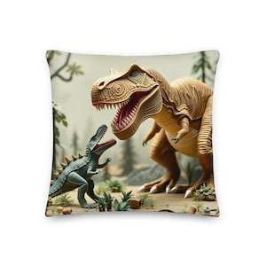 May include: A square throw pillow featuring a printed illustration of a large tan Tyrannosaurus Rex facing a smaller green dinosaur with spikes on its back. The scene includes stylized trees and plants in a desert-like landscape with a light background.