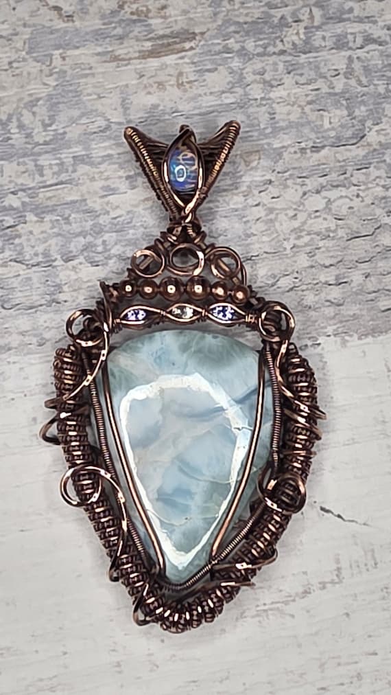 A bright Larimar accented with an Opal, Tanzanite and White Sapphire.