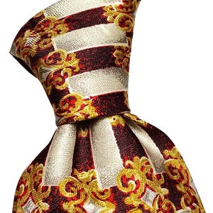 May include: A necktie featuring a repeating pattern of vertical stripes in alternating cream and deep red. The fabric is adorned with an intricate, ornate gold filigree design that overlays the stripes, creating a textured and layered visual effect.