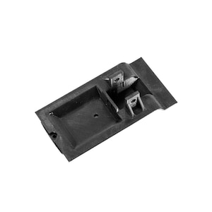 May include: A black, rectangular plastic component with raised sections and a recessed area. The component has two small, rectangular protrusions and a small hole. The object is set against a white background.