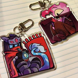 May include: A set of three ceramic mugs with a speckled, matte finish. The mugs are in shades of cream, light gray, and dark gray. Each mug has a simple, minimalist design and a rounded handle.