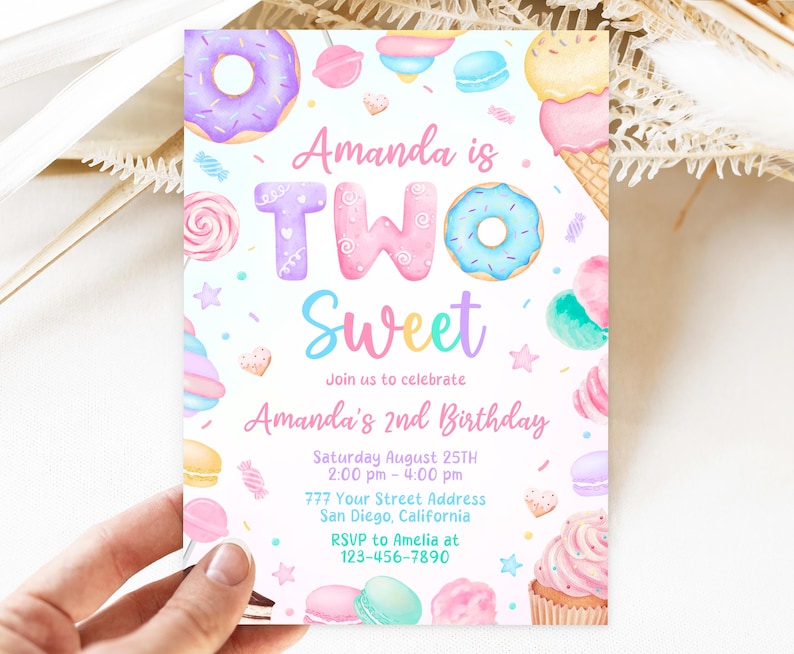 May include: A colorful invitation for a second birthday party with a sweet theme. The invitation features a donut, a cupcake, a lollipop, and other sweet treats. The text on the invitation reads "Amanda is Two Sweet" and includes the date, time, and location of the party. RSVP information is also included.