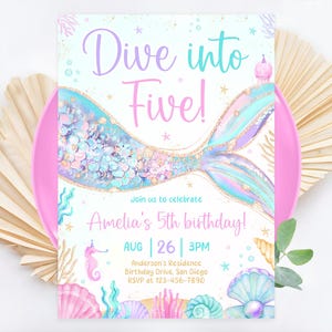 May include: A mermaid tail with iridescent scales and gold glitter, with the text "Dive into Five!" and "Amelia's 5th birthday!" on a white background. The invitation includes the date and time of the party, as well as the location and RSVP information.