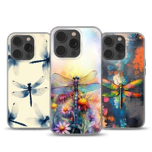May include: Three phone cases with dragonfly designs. One case has a cream background with blue dragonflies. The second case features a colorful dragonfly with flowers. The third case has an abstract art background with a dragonfly.
