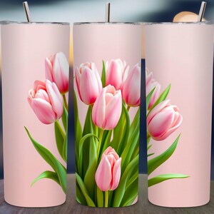 Pode incluir: Três copos de aço inoxidável rosa com um design floral rosa que apresenta um buquê de tulipas rosa.