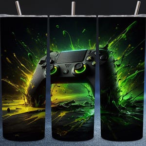May include: A black tumbler with a vibrant design featuring a video game controller. The controller is highlighted with neon green accents against a backdrop of yellow and green splashes, creating a dynamic and energetic visual.