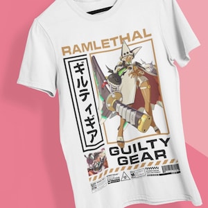 May include: White t-shirt with a graphic print of a character from the video game Guilty Gear. The character is Ramlethal Valentine, and the text on the shirt says "Ramlethal" and "Guilty Gear".