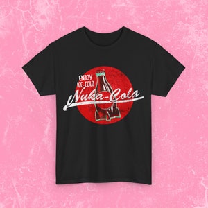 May include: Black t-shirt with a red circle and a vintage-style graphic of a bottle of Nuka-Cola. The text reads "Enjoy Ice-Cold Nuka-Cola".