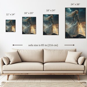May include: A digital illustration of a woman in a white dress holding a sword, with a stormy sky in the background. The image is shown in different sizes, with a sofa in the foreground.