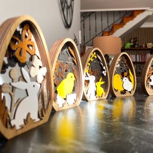 5 różnych drewnianych dekoracji na jajka wielkanocne w jednym. Wielowarstwowa ozdoba wielkanocna 3D. Króliczki, pisklęta i jajka. zdjęcie 1
