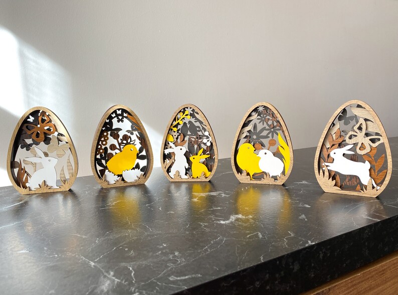 5 różnych drewnianych dekoracji na jajka wielkanocne w jednym. Wielowarstwowa ozdoba wielkanocna 3D. Króliczki, pisklęta i jajka. zdjęcie 3