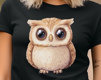 May include: Black t-shirt featuring a cartoon owl with large, expressive eyes. The owl is depicted in shades of brown and cream, with a detailed feather design. The t-shirt is a classic crew neck style.