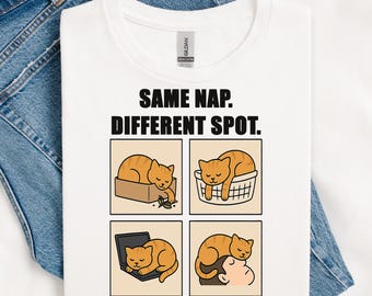 May include: White t-shirt featuring the text "SAME NAP. DIFFERENT SPOT." and four panels showing an orange cat sleeping in various places: a box, a basket, a laptop, and on a person's head.