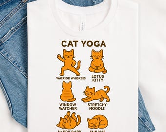 May include: White t-shirt with the text "CAT YOGA" and illustrations of orange cats in various yoga poses. Poses include Warrior Whiskers, Lotus Kitty, Window Watcher, Stretchy Noodle, Happy Baby, and Sun Nap.