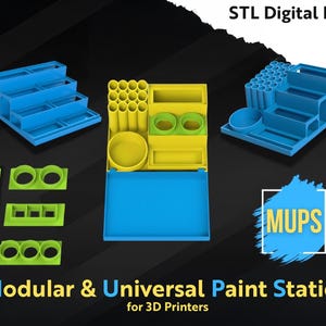 May include: A selection of modular paint station components in blue and yellow, designed for 3D printers. The image shows various trays, holders, and containers, with the text "STL Digital Files" and "Modular & Universal Paint Station for 3D Printers".