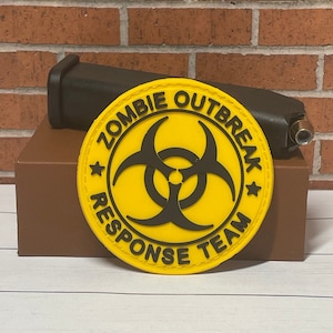 May include: Yellow round patch with a black biohazard symbol and the text "Zombie Outbreak Response Team" in a black circle.
