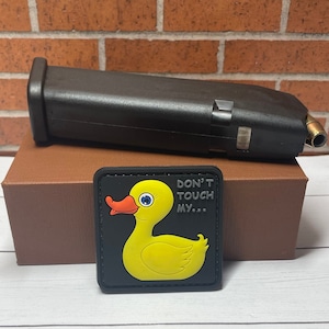May include: A black patch with a yellow rubber ducky and the text "Don't Touch My..."
