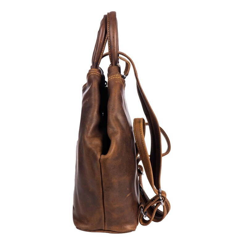 May include: A brown leather backpack with adjustable straps. The bag has a top handle and a drawstring closure.