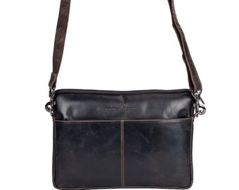 May include: A dark brown leather crossbody bag featuring a rectangular shape, a top zipper closure, and an adjustable fabric shoulder strap. The front includes an exterior slip pocket with visible contrast stitching and the embossed Green Wood logo.