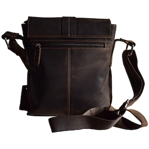 May include: A brown leather messenger bag with a flap closure and an adjustable shoulder strap. The bag has a zippered pocket on the front and a small pocket on the back.