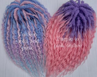 May include: Two sets of synthetic dreadlocks in a heart shape. One set is blue, violet, and pink, with the text "Unicorn violet and pink." The other set is purple to pink ombre, with the text "Purple to pink ombre."