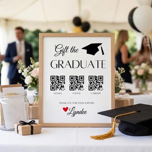May include: A framed sign with the text Gift the GRADUATE, a graduation cap icon, three QR codes labeled Venmo, Paypal, and Cashapp, the text Thank you for your support, a red heart, and the name Lyndee in black script font.
