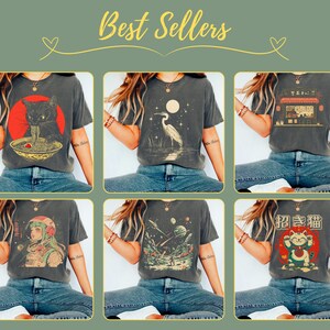 May include: Six different t-shirt designs featuring various graphic prints. The designs include a cat eating ramen, a crane, a Japanese restaurant, a space scene, and a cat with Japanese text. The shirts are all dark gray and have a relaxed fit.