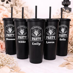 May include: Five black tumblers with lids and straws, each personalized with a name. The tumblers have a white graphic that says "TIL DEATH DO US PARTY" with a skeleton hand design. The names are Shannon, Nikk&eacute;, Emily, Lauren, and Bella.