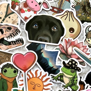 May include: A selection of vibrant stickers with diverse illustrations. Includes a black Labrador's face, a frog in a cowboy hat, a heart-shaped lollipop, a smiling sun, and a cartoon cow with strawberry markings.