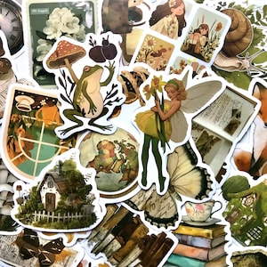 May include: A collection of vintage-style stickers featuring whimsical illustrations of a frog, a fairy, a mushroom, a butterfly, a snail, a house, and a globe. The stickers are printed on white paper with a matte finish.