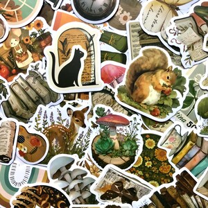 May include: A collection of vintage-style stickers featuring various illustrations, including a black cat, a squirrel, a deer, mushrooms, a guitar, and a book. The stickers are printed on white paper with a glossy finish.