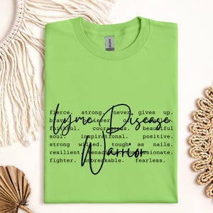 May include: A light green t-shirt with black text that reads "Lyme Disease" and defines the word with positive attributes such as "fierce", "strong", "never gives up", "brave", "believer", "courageous", "beautiful", "faithful", "inspirational", "positive", "strong willed", "tough as nails", "resilient", "passionate", "fighter", "unbreakable", and "fearless".