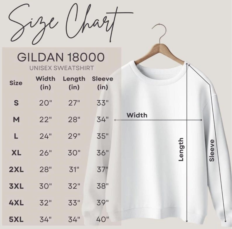 Puede incluir: Una sudadera unisex blanca Gildan 18000 cuelga de una percha de madera. La imagen incluye una tabla de tallas con medidas en cm para el ancho, largo y largo de manga, que van desde la talla S hasta la 5XL.