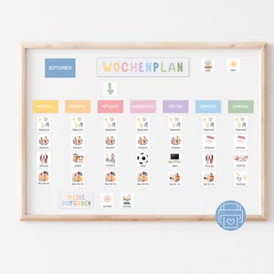 以下が含まれることがあります： カラフルな文字で「WOCHENPLAN」と書かれた木枠の週間プランナー。プランナーには曜日、アイコン、9月が含まれています。毎日の活動を整理するために設計されています。
