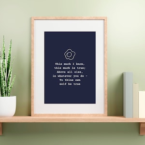 May include: A navy blue framed print with a white outline of a fried egg and the text "This much I know, this much is true; Above all else, in whatever you do - To thine own self be true."